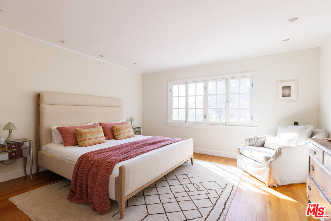 4207 Dundee Drive Los Angeles, CA 90027 - Photo 24 of 33 a bedroom with a bed and a window with a couch