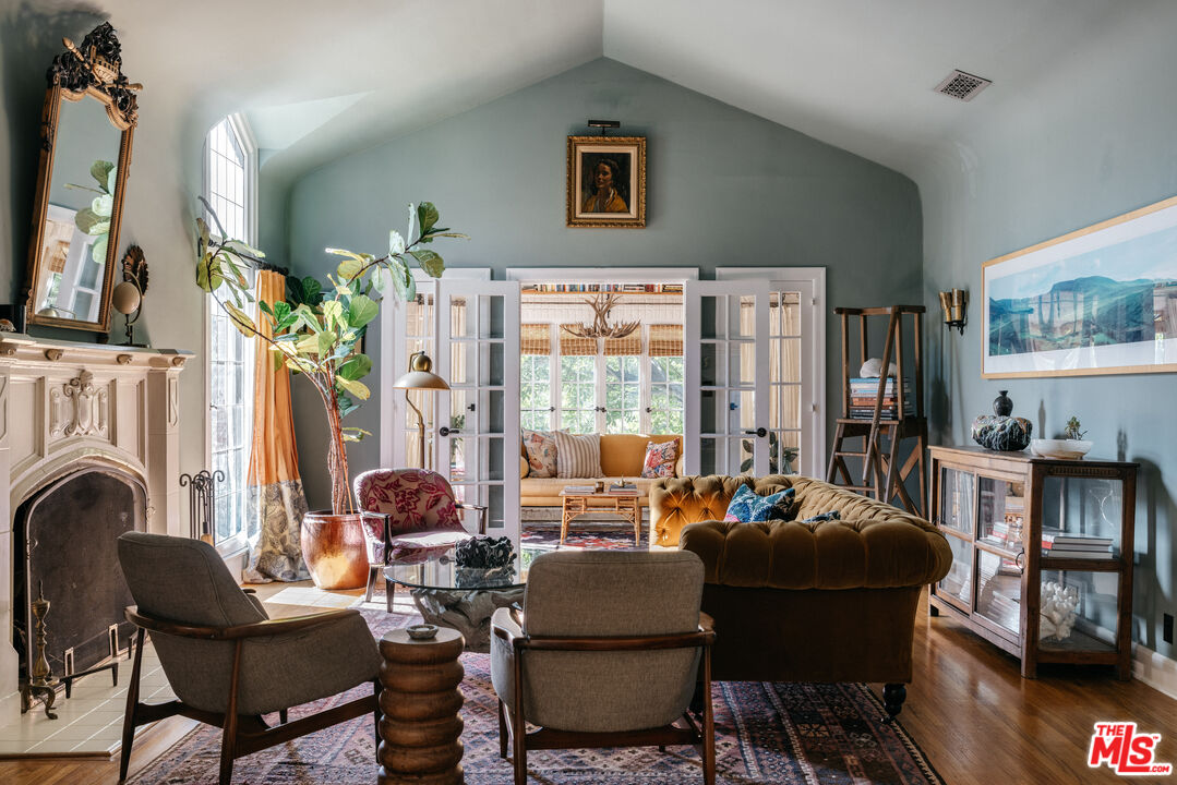 4207 Dundee Drive Los Angeles, CA 90027 - Photo 4 of 33 a living room with fireplace furniture and a large window