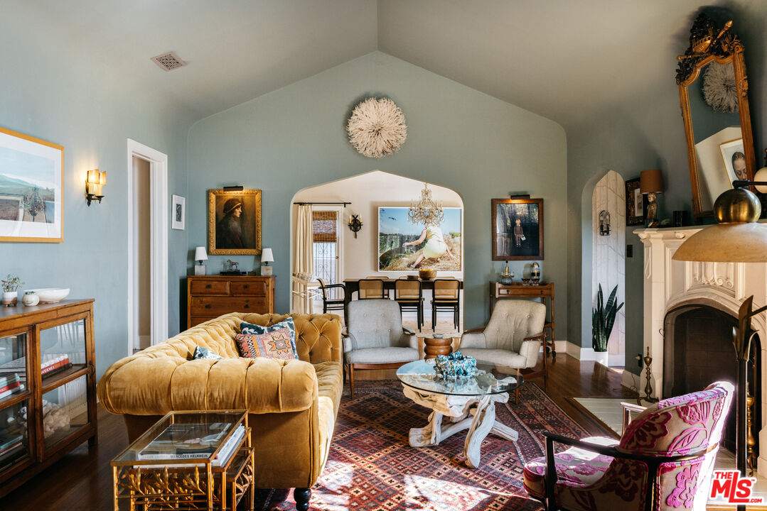 4207 Dundee Drive Los Angeles, CA 90027 - Photo 7 of 33 a living room with furniture a fireplace and a flat screen tv