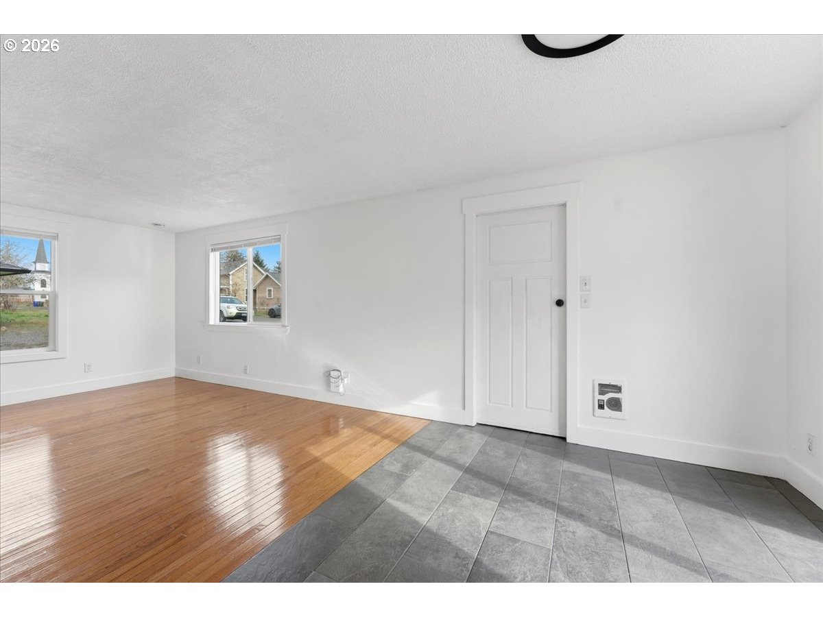 369 South 16th Avenue Cornelius, OR 97113 - Photo 12 of 29 a view of an empty room with wooden floor and a window