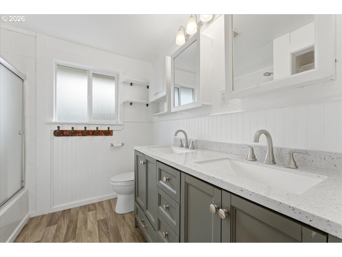 369 South 16th Avenue Cornelius, OR 97113 - Photo 22 of 29 a bathroom with a granite countertop sink a toilet and a mirror