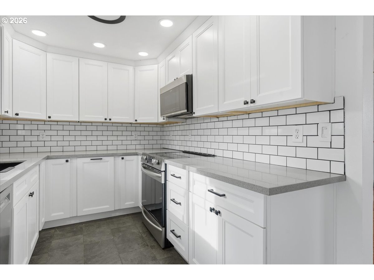369 South 16th Avenue Cornelius, OR 97113 - Photo 26 of 29 a kitchen with granite countertop white cabinets and white appliances