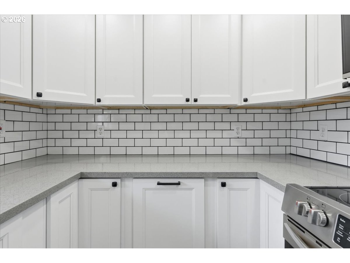 369 South 16th Avenue Cornelius, OR 97113 - Photo 28 of 29 a kitchen with granite countertop white cabinets and a stove