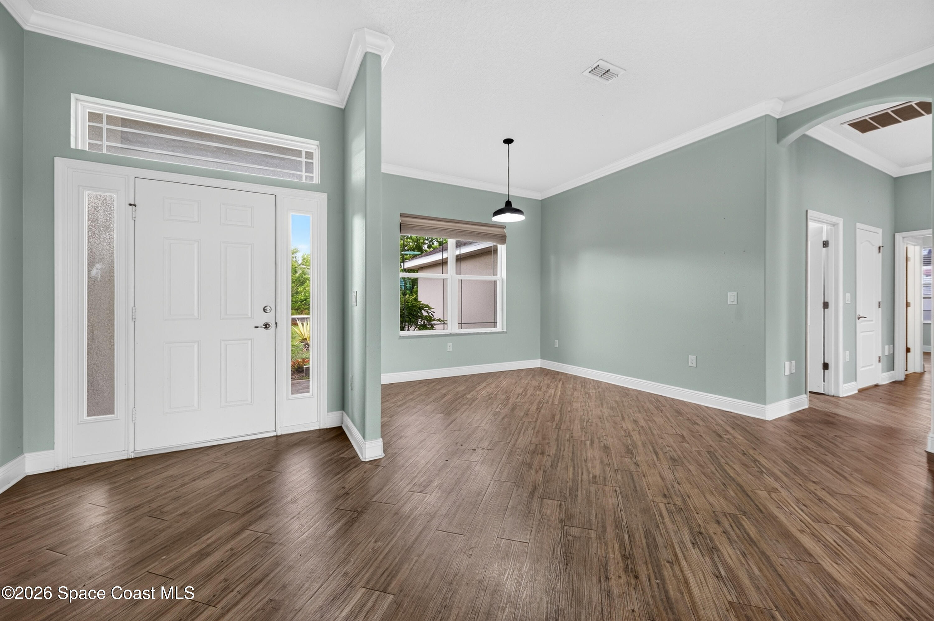 1475 Dalbora Road Merritt Island, FL 32953 - Photo 13 of 57 an empty room with wooden floor and windows