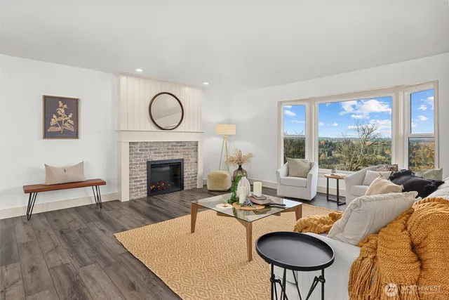 a living room with furniture a table and a fireplace