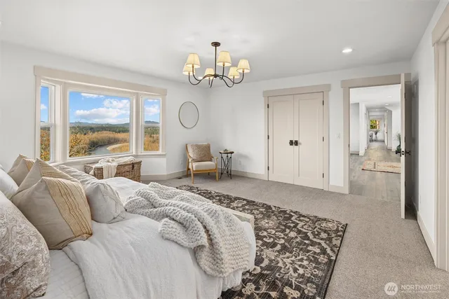 a bed room with a bed mirror and a large window