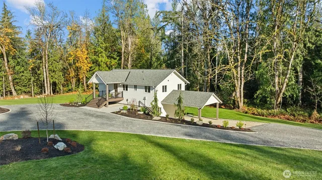 an aerial view of a house with swimming pool and big yard