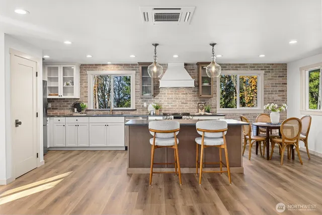 a kitchen with a table chairs stove and cabinets