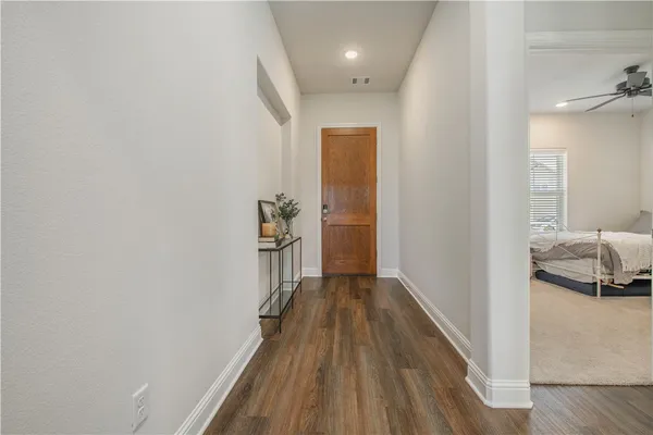 a view of a hallway view with wooden floor and staircase