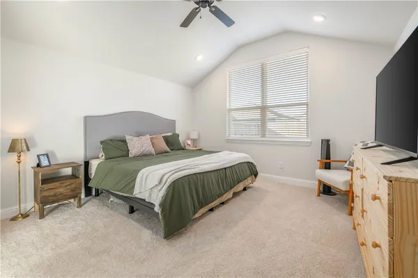 a bedroom with a bed and a chair