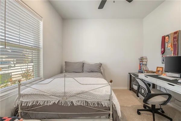 a bedroom with a bed and a chair