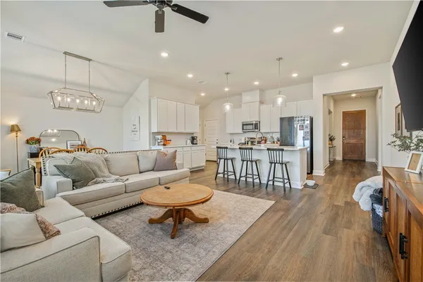 a living room with furniture and kitchen view