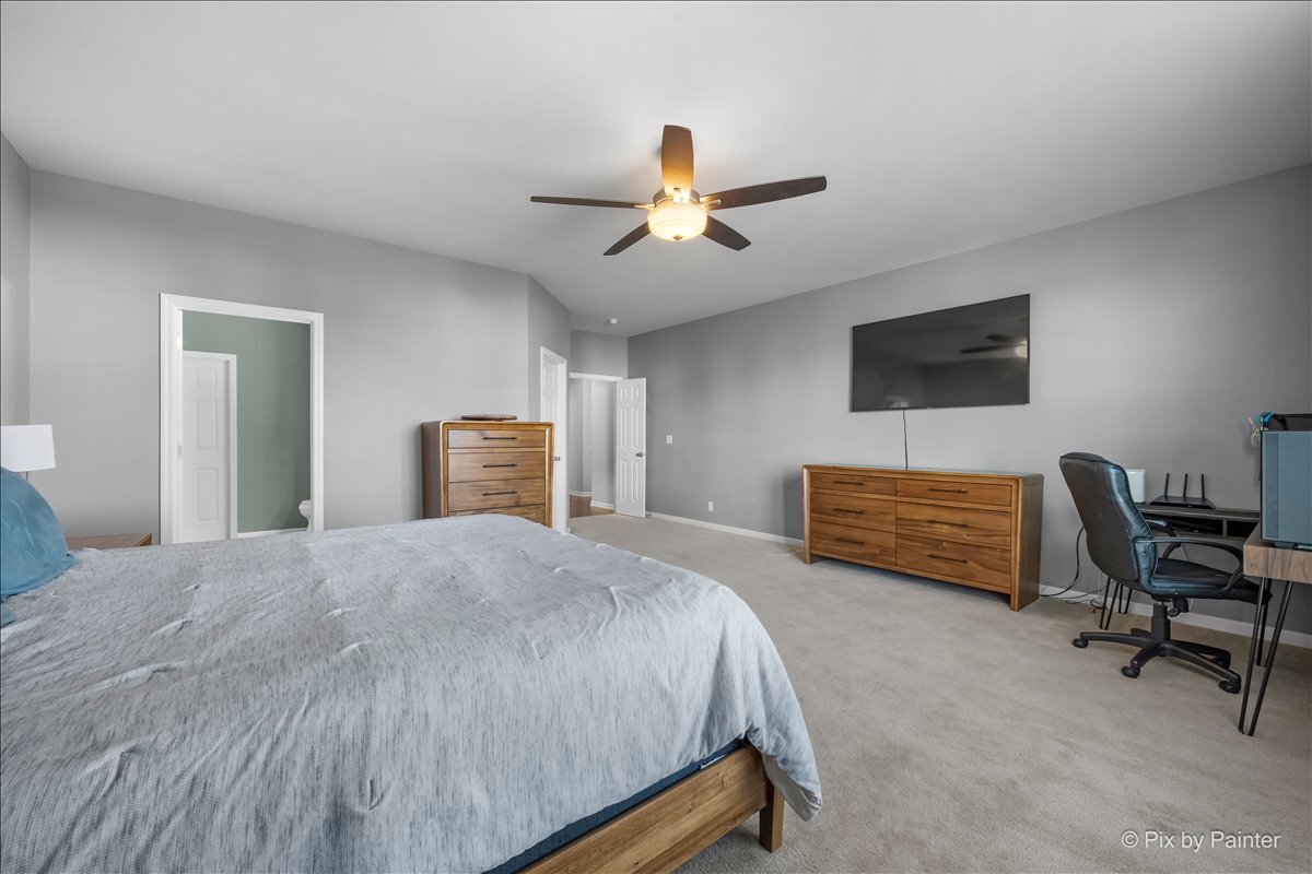691 Windett Ridge Road Yorkville, IL 60560 - Photo 18 of 42 a bedroom with a bed a furniture and a flat screen tv