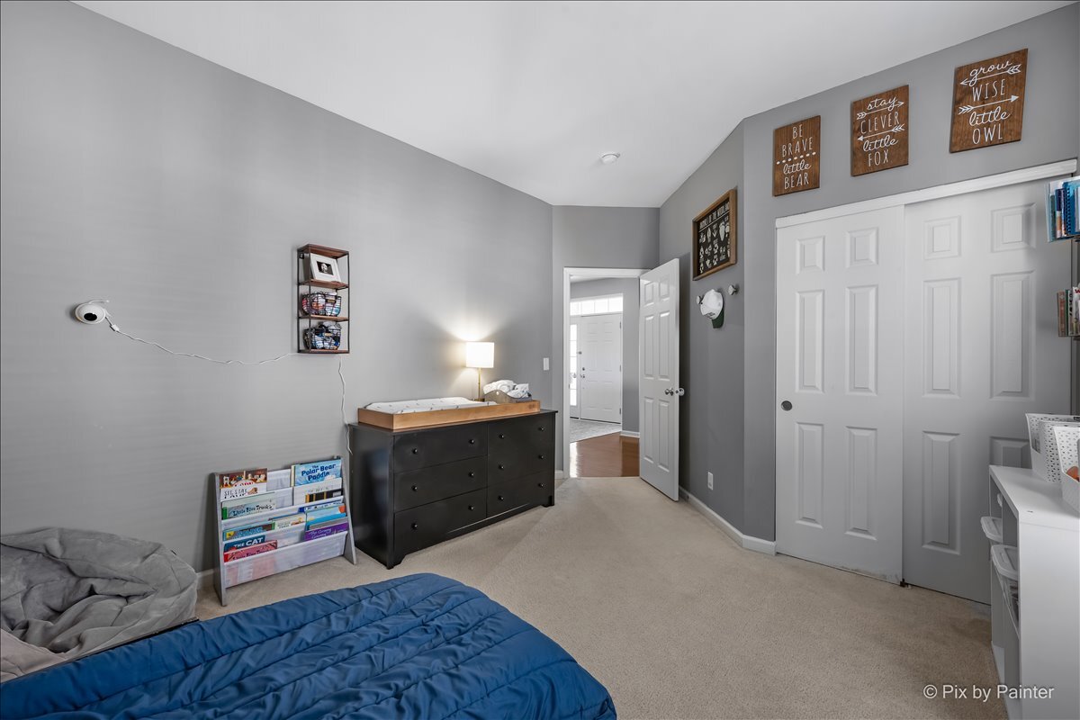 691 Windett Ridge Road Yorkville, IL 60560 - Photo 23 of 42 a bedroom with a bed and wooden floor