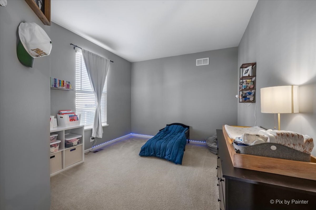 691 Windett Ridge Road Yorkville, IL 60560 - Photo 24 of 42 a bedroom with a bed and a window