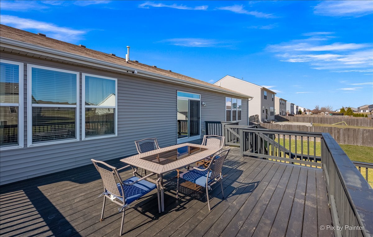 691 Windett Ridge Road Yorkville, IL 60560 - Photo 35 of 42 a roof deck with a dining table and chairs with wooden floor