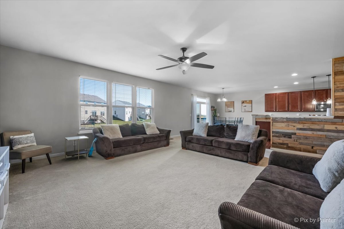 691 Windett Ridge Road Yorkville, IL 60560 - Photo 7 of 42 a living room with furniture and a large window