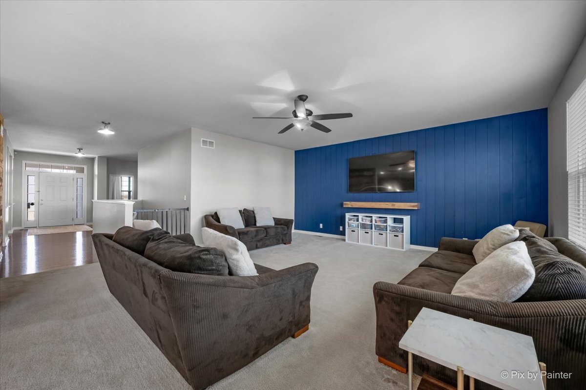 691 Windett Ridge Road Yorkville, IL 60560 - Photo 9 of 42 a living room with furniture and a flat screen tv