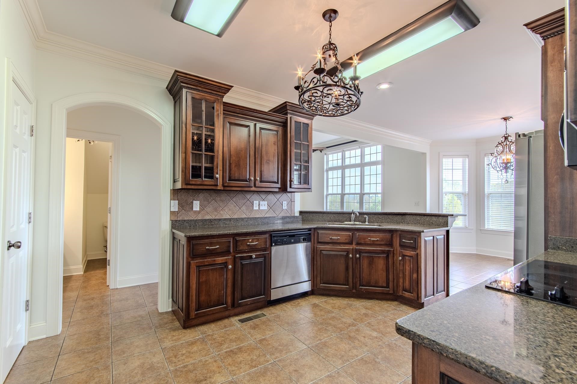 5166 Middlefork Road Luray, TN 38352 - Photo 12 of 40 a large kitchen with stainless steel appliances granite countertop a stove and a sink