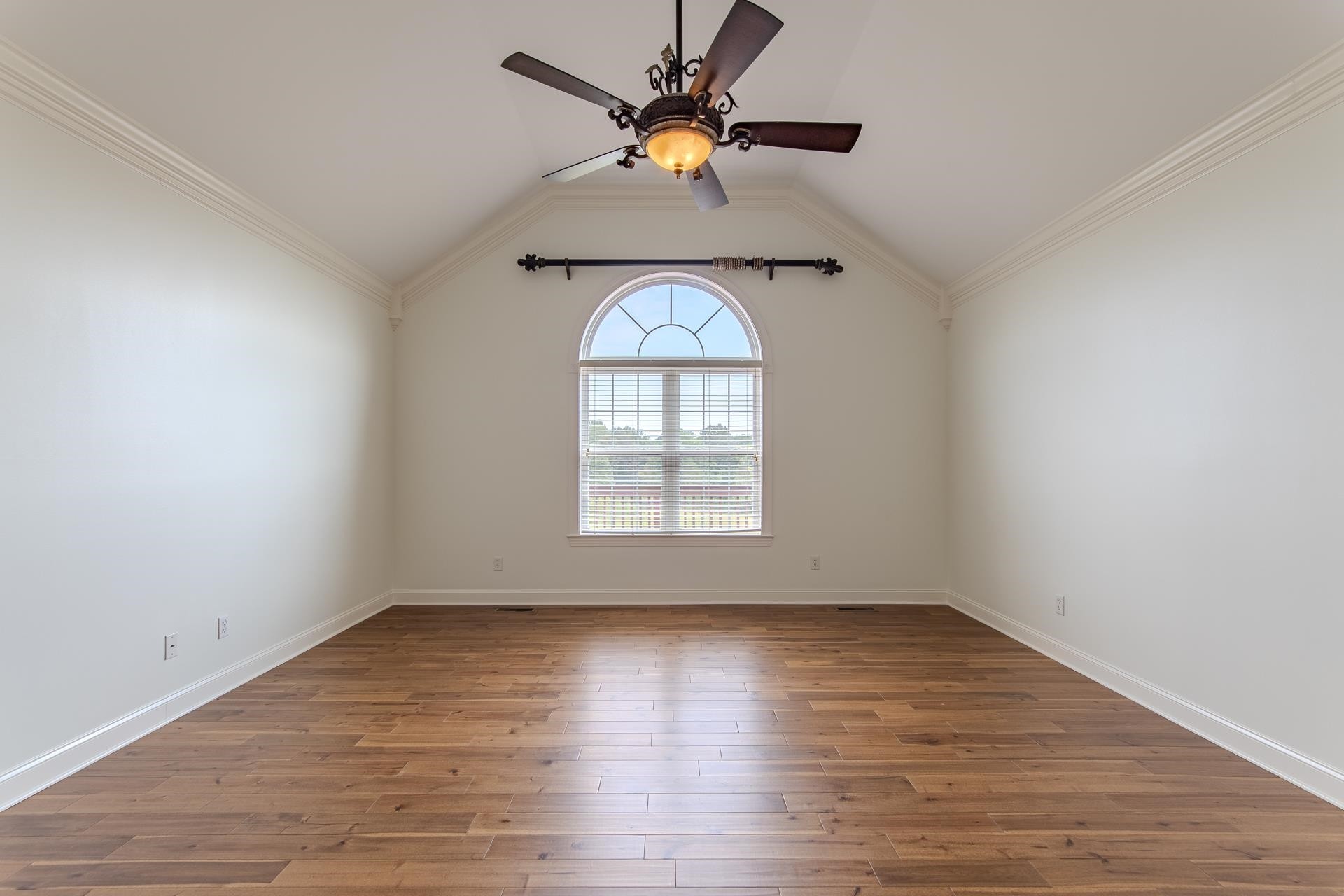 5166 Middlefork Road Luray, TN 38352 - Photo 19 of 40 an empty room with wooden floor chandelier fan and windows