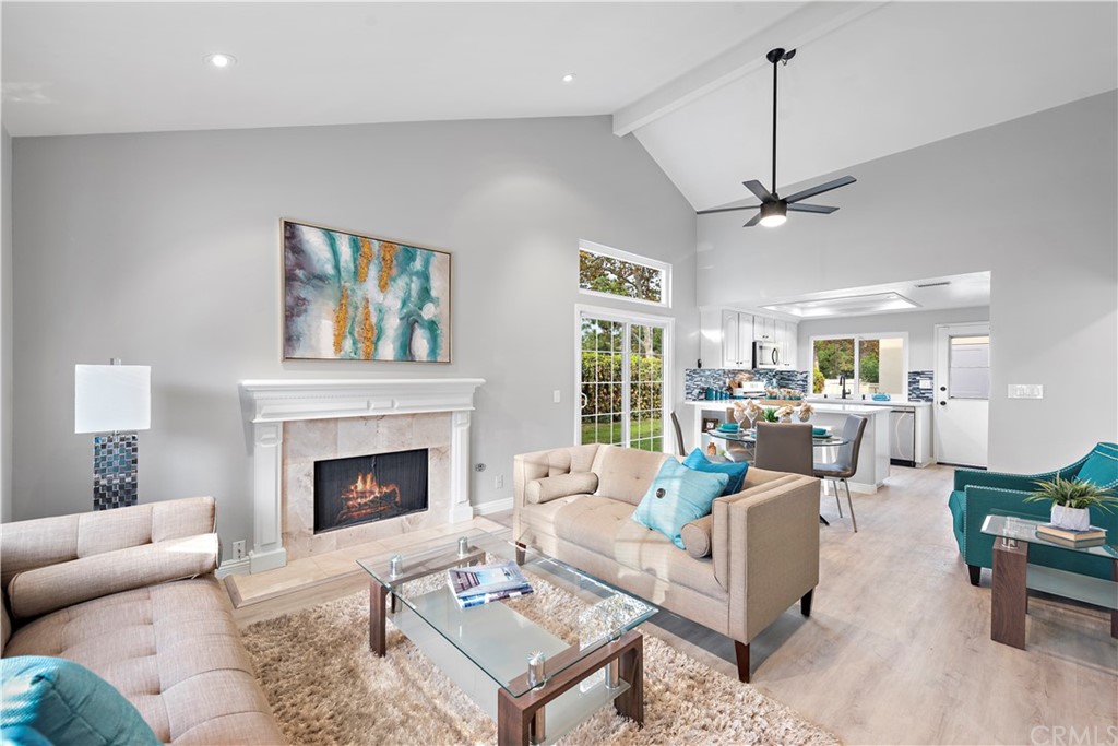 16 Racing Wind Irvine, CA 92614 - Photo 1 of 1 a living room with furniture a chandelier and a fireplace