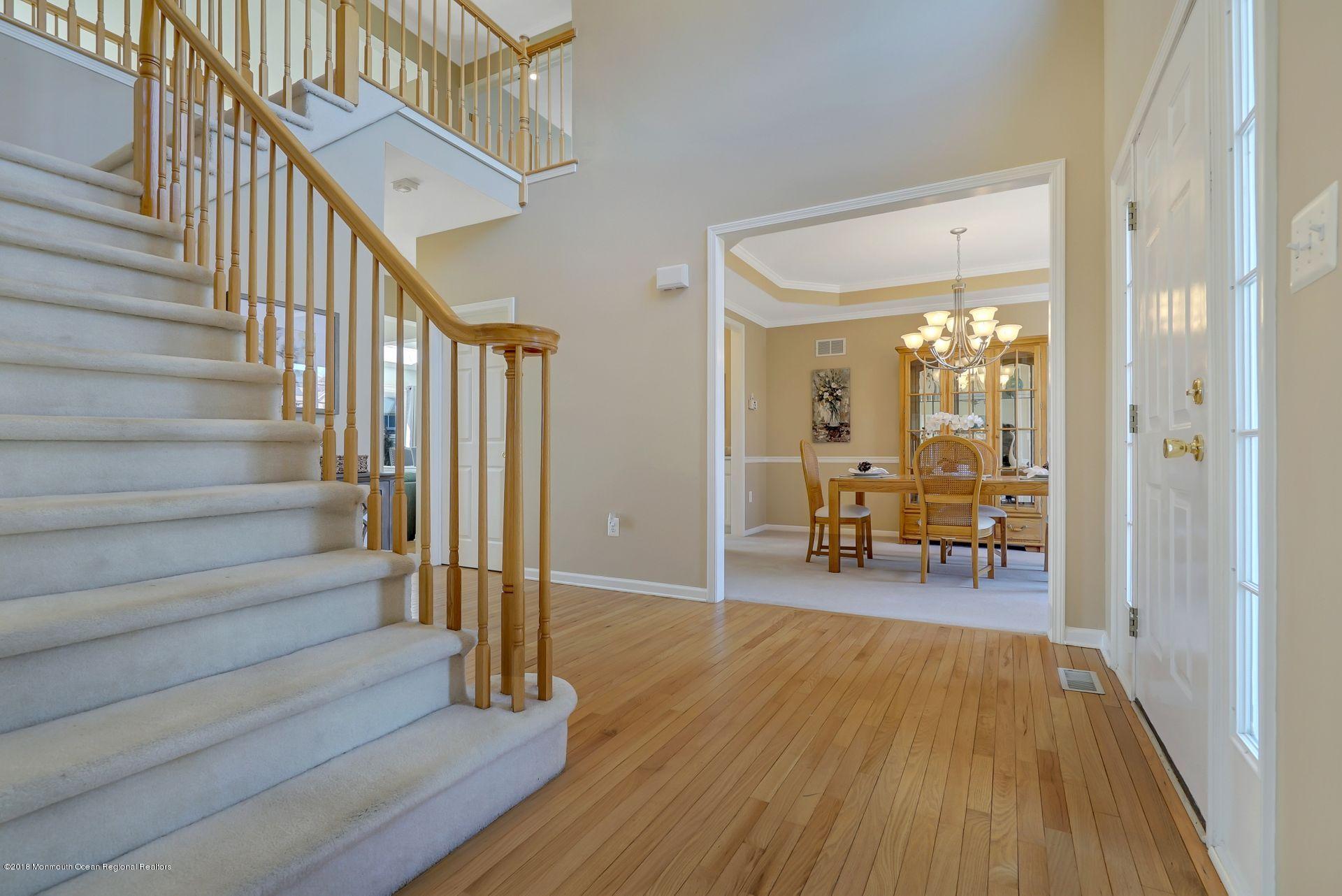 263 Pin Oak Road Freehold, NJ 07728 - Photo 13 of 60 a view of entryway livingroom and hall with wooden floor