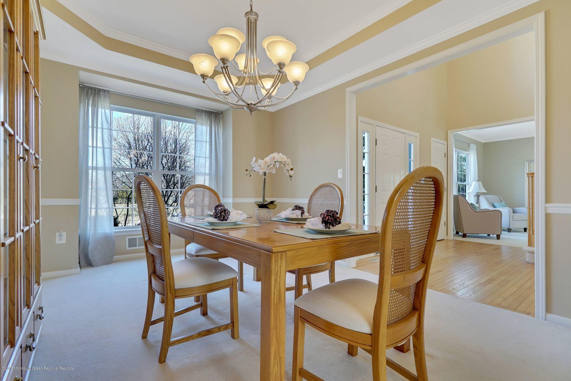 263 Pin Oak Road Freehold, NJ 07728 - Photo 15 of 60 a view of a dining room with furniture and chandelier