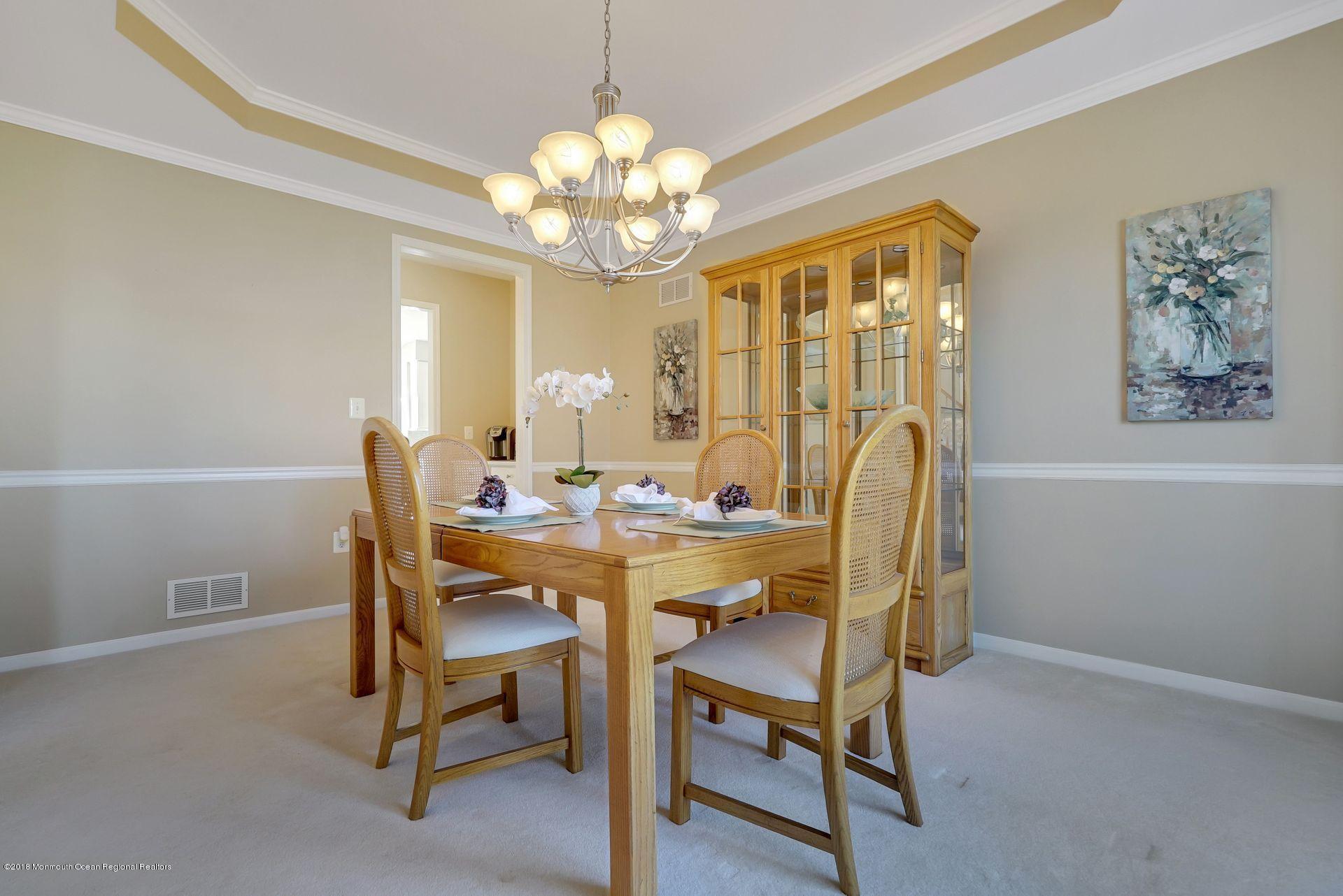 263 Pin Oak Road Freehold, NJ 07728 - Photo 16 of 60 a view of a dining room with furniture and chandelier