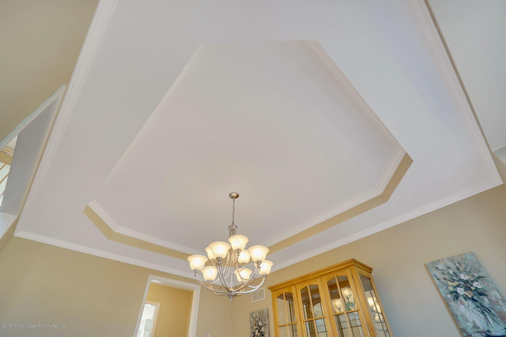 263 Pin Oak Road Freehold, NJ 07728 - Photo 17 of 60 a view of a livingroom with a chandelier fan
