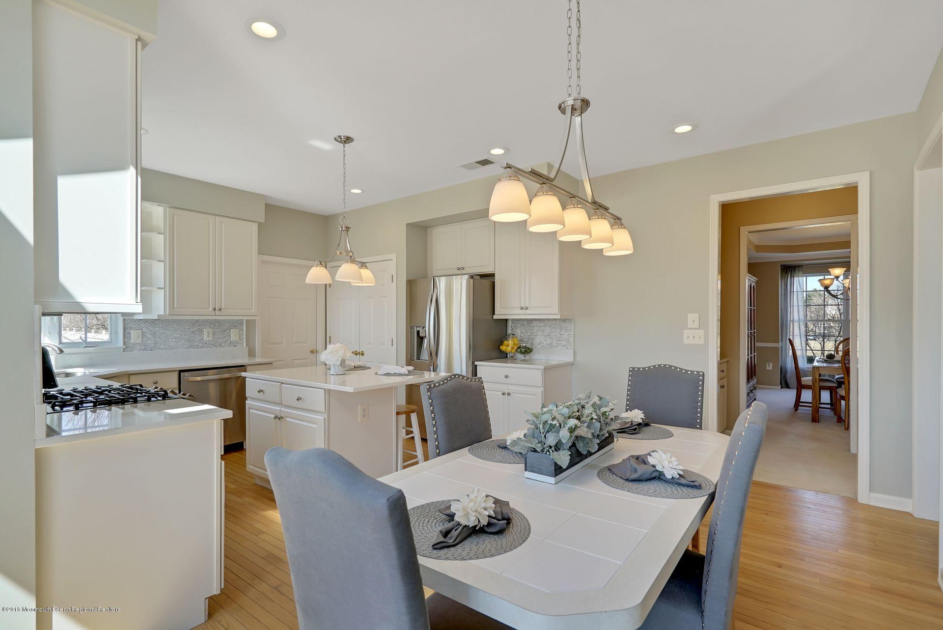 263 Pin Oak Road Freehold, NJ 07728 - Photo 20 of 60 a dining room filled chandelier and kitchen view