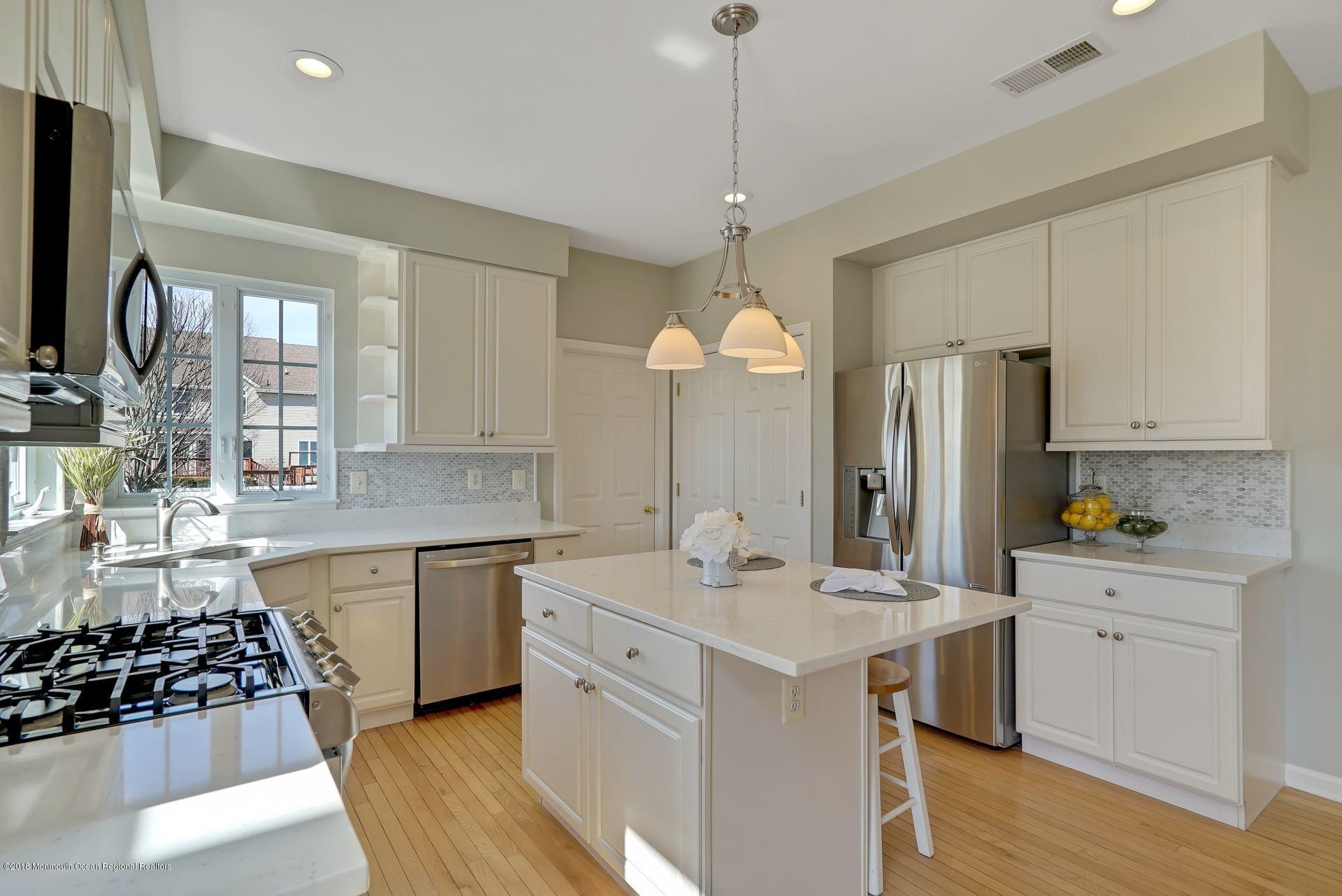 263 Pin Oak Road Freehold, NJ 07728 - Photo 21 of 60 a kitchen with a sink stove and refrigerator