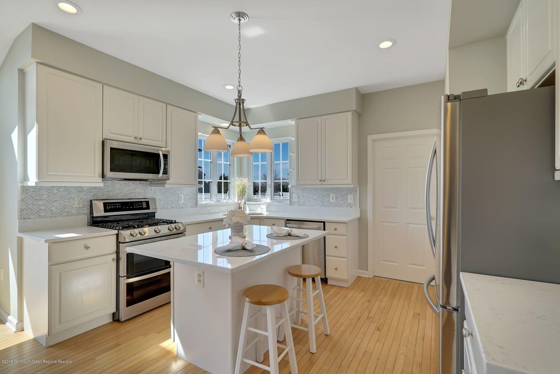 263 Pin Oak Road Freehold, NJ 07728 - Photo 22 of 60 a kitchen with stainless steel appliances a stove refrigerator and microwave