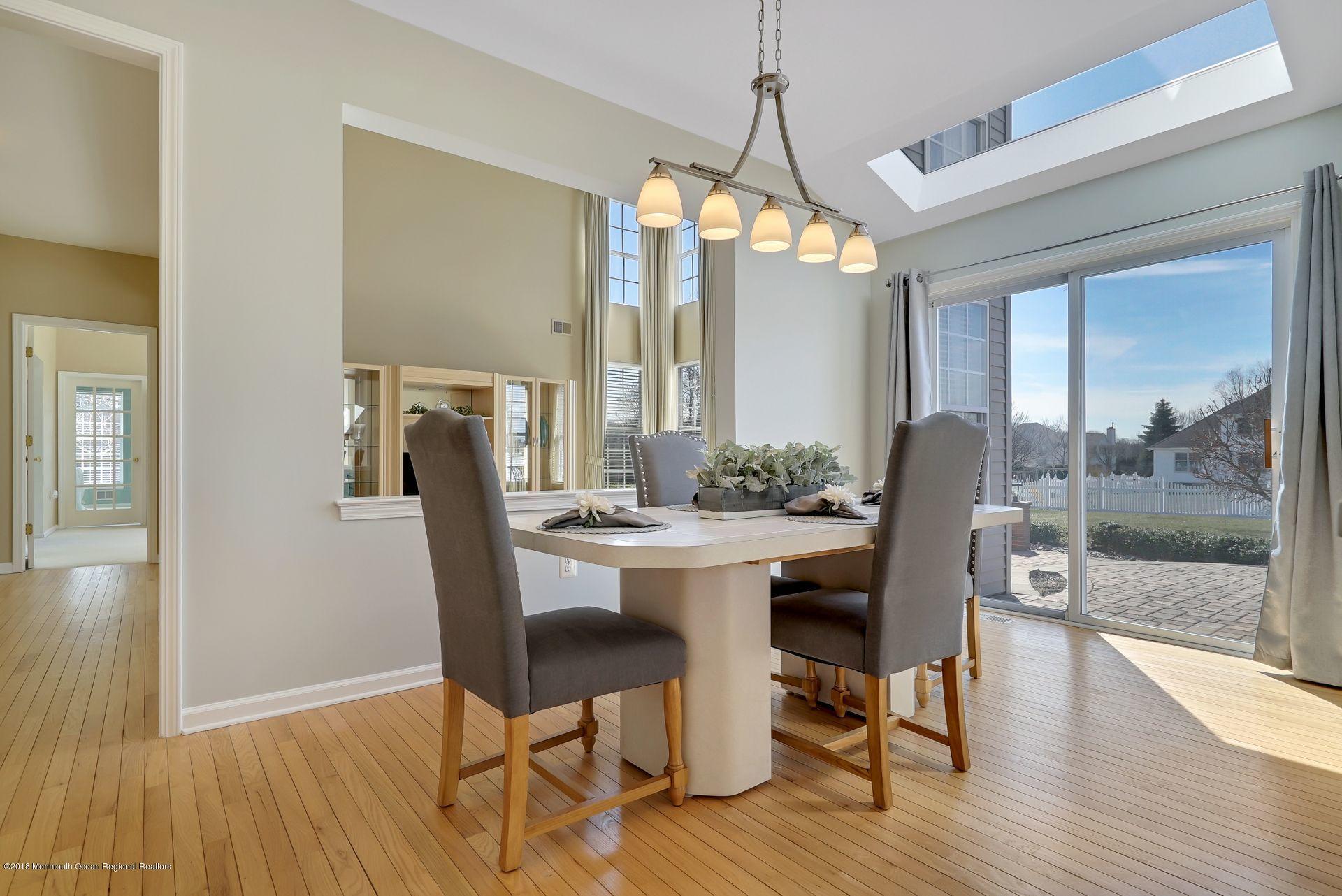 263 Pin Oak Road Freehold, NJ 07728 - Photo 23 of 60 a view of a dining room with furniture window and wooden floor