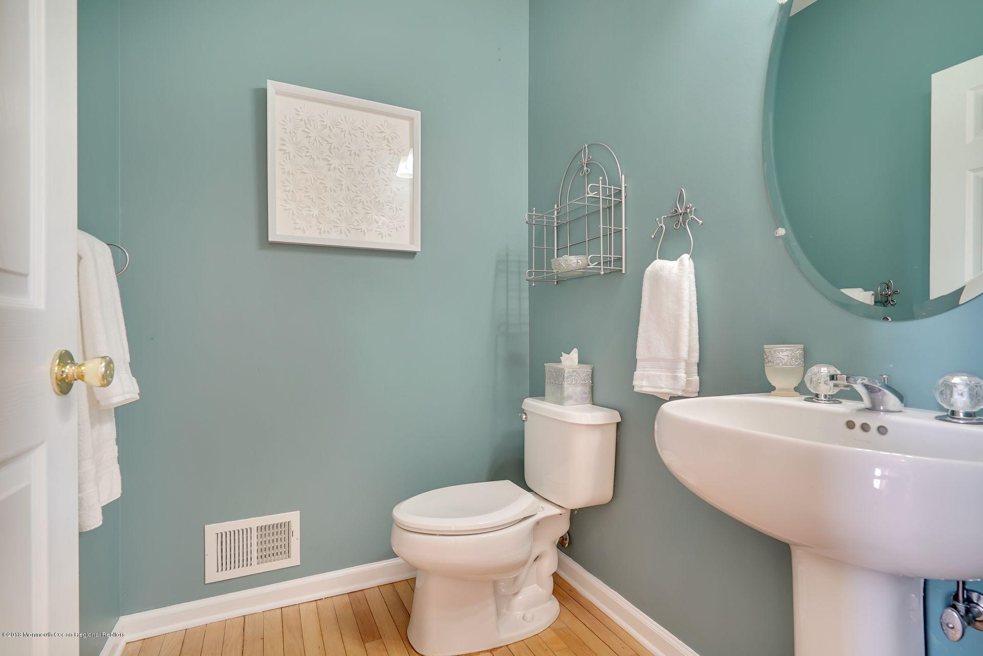 263 Pin Oak Road Freehold, NJ 07728 - Photo 28 of 60 a bathroom with a toilet sink and mirror
