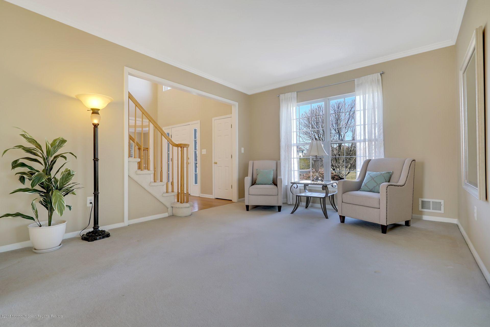 263 Pin Oak Road Freehold, NJ 07728 - Photo 33 of 60 a living room with furniture and a floor to ceiling window