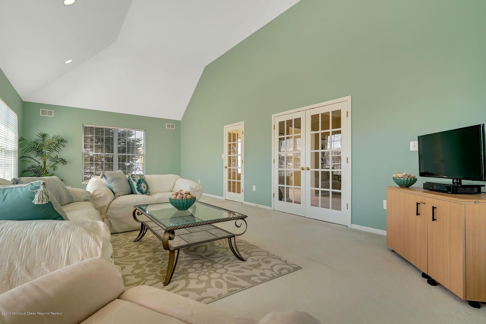 263 Pin Oak Road Freehold, NJ 07728 - Photo 35 of 60 a living room with furniture and a flat screen tv