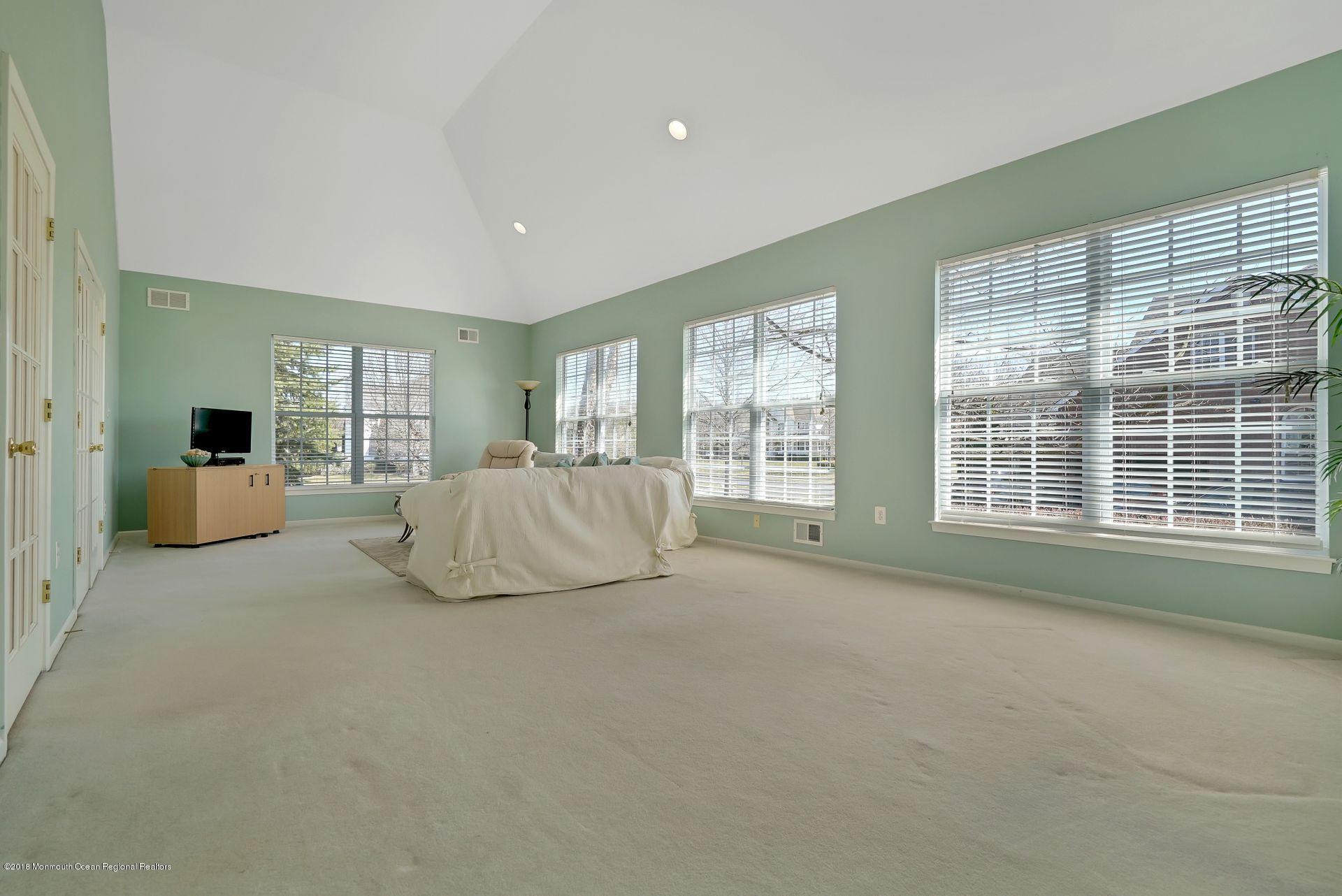 263 Pin Oak Road Freehold, NJ 07728 - Photo 36 of 60 a large bedroom with a large bed and a large window