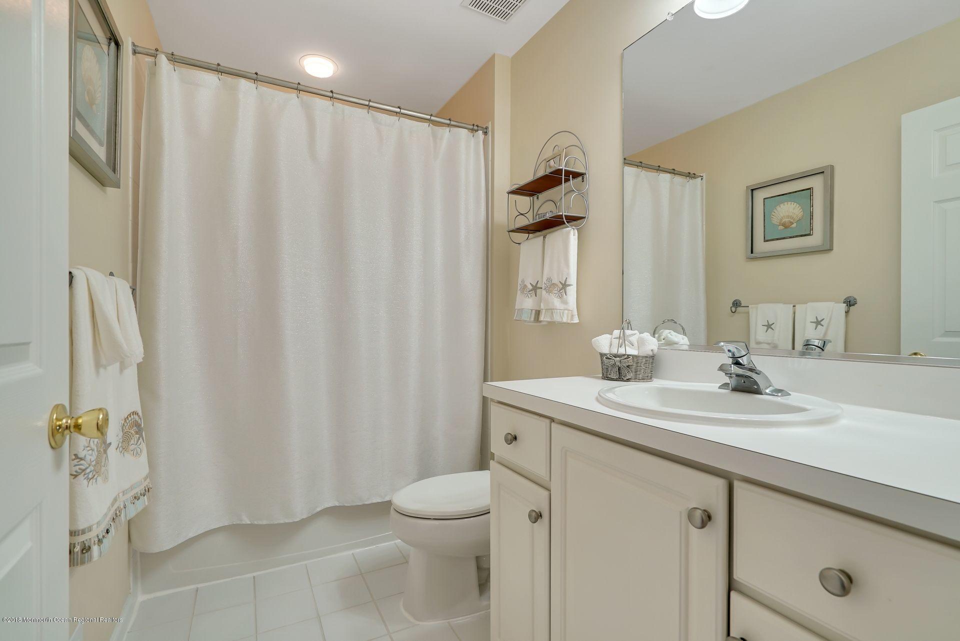 263 Pin Oak Road Freehold, NJ 07728 - Photo 39 of 60 a bathroom with a sink a toilet and shower