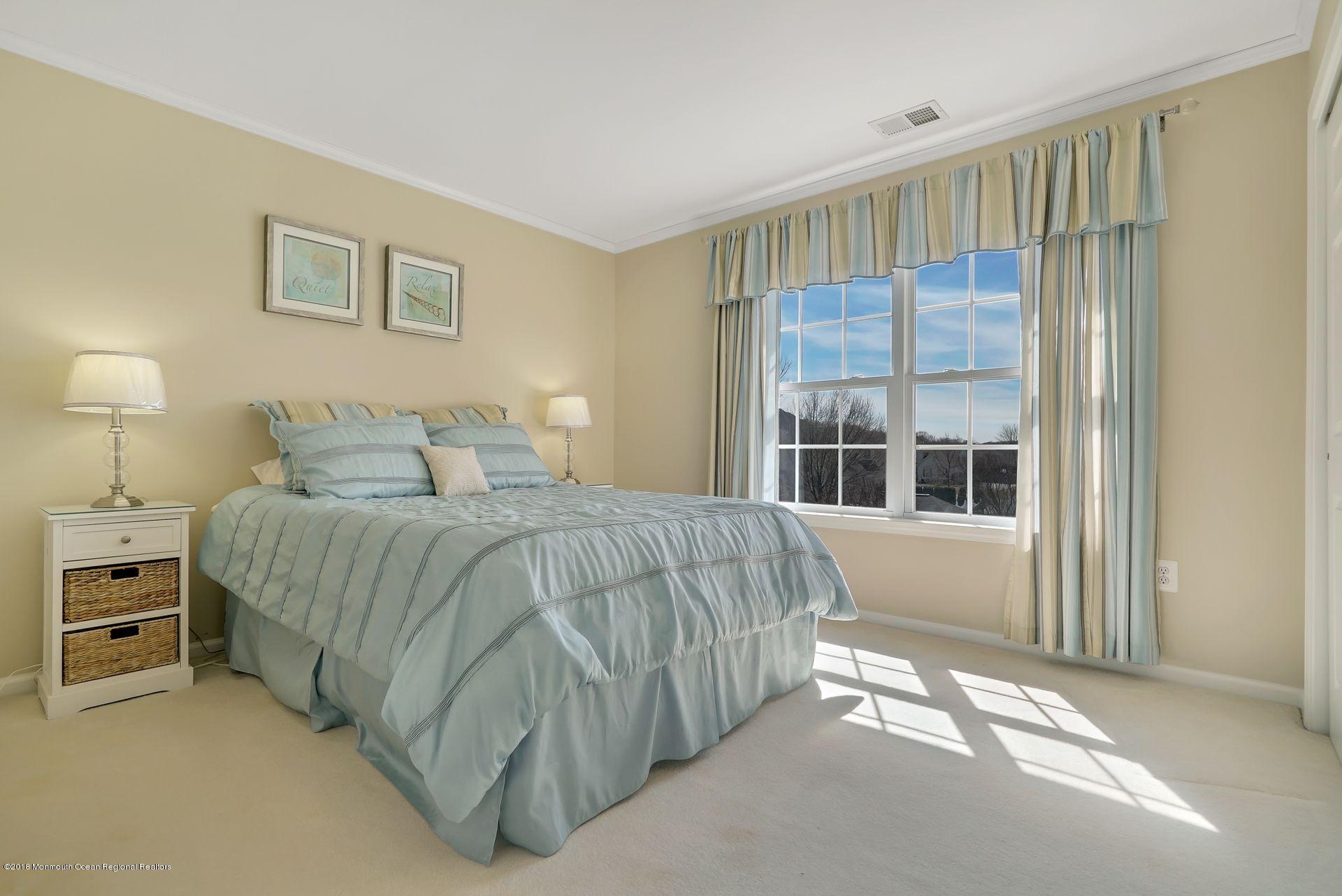263 Pin Oak Road Freehold, NJ 07728 - Photo 40 of 60 a bedroom with a bed and a large window