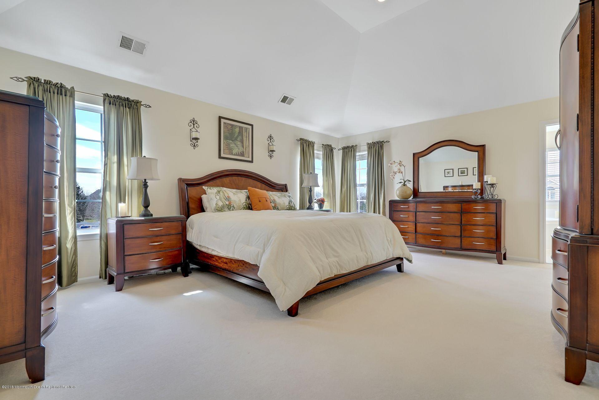 263 Pin Oak Road Freehold, NJ 07728 - Photo 42 of 60 a bedroom with a bed and a dresser