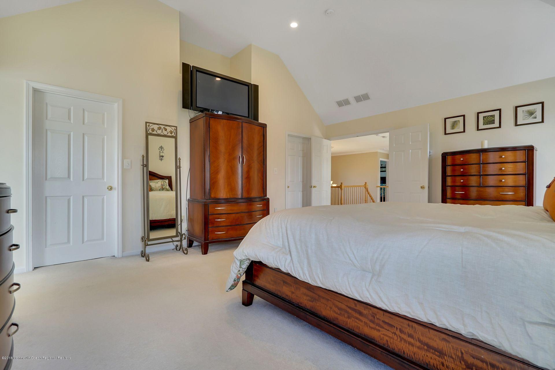 263 Pin Oak Road Freehold, NJ 07728 - Photo 43 of 60 a bed room with a bed and a television