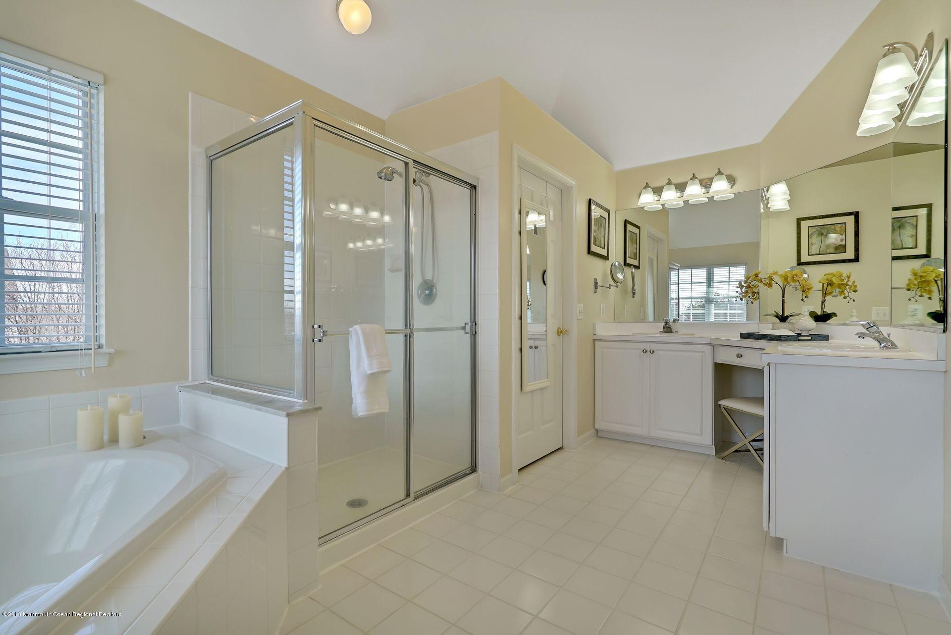 263 Pin Oak Road Freehold, NJ 07728 - Photo 44 of 60 a bathroom with a double vanity sink mirror and shower