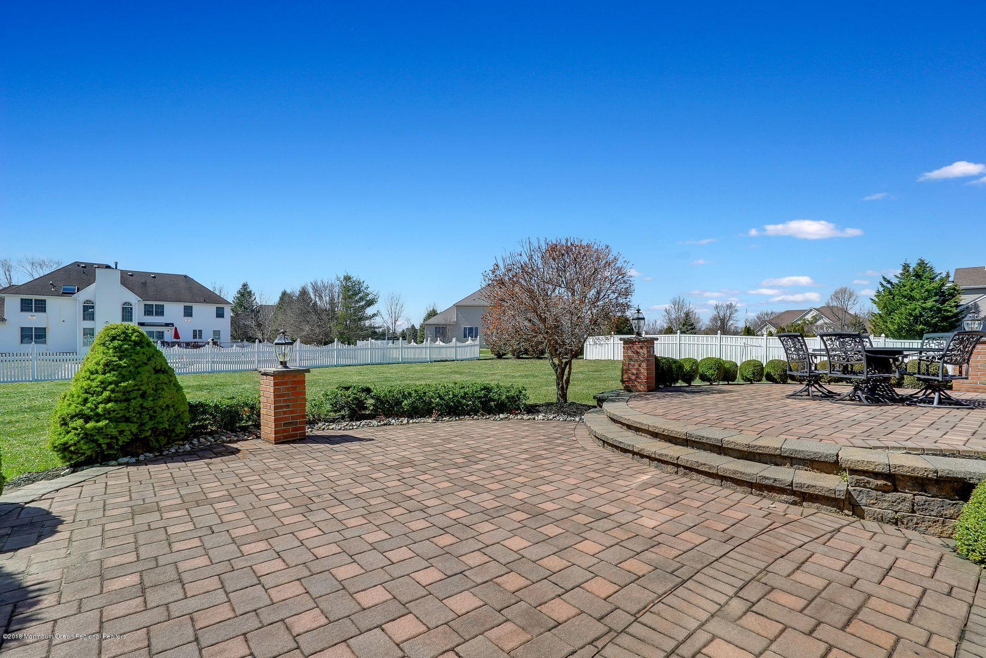 263 Pin Oak Road Freehold, NJ 07728 - Photo 48 of 60 a view of a park with plants and a bench