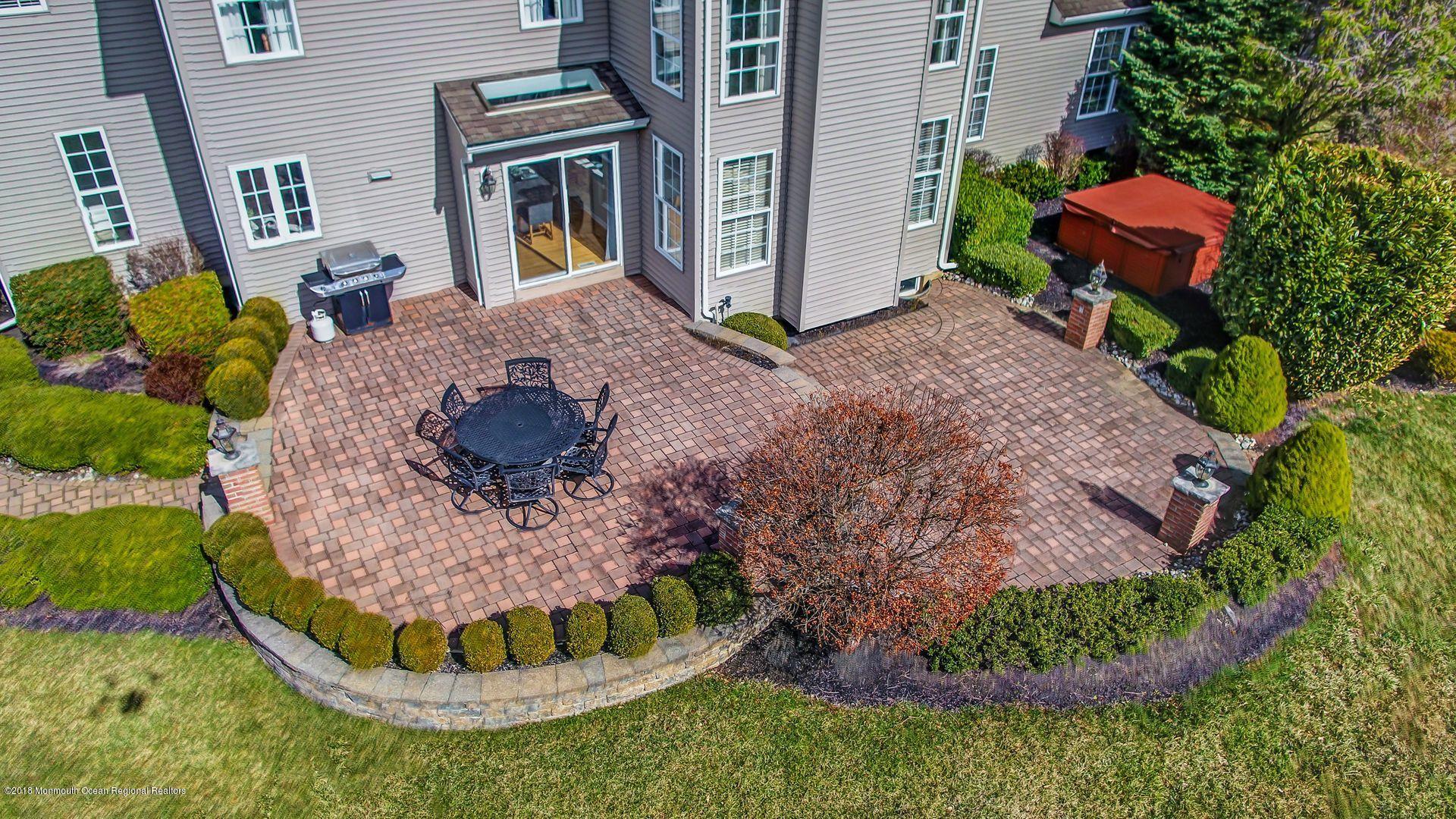 263 Pin Oak Road Freehold, NJ 07728 - Photo 59 of 60 a view of a backyard with plants and outdoor seating