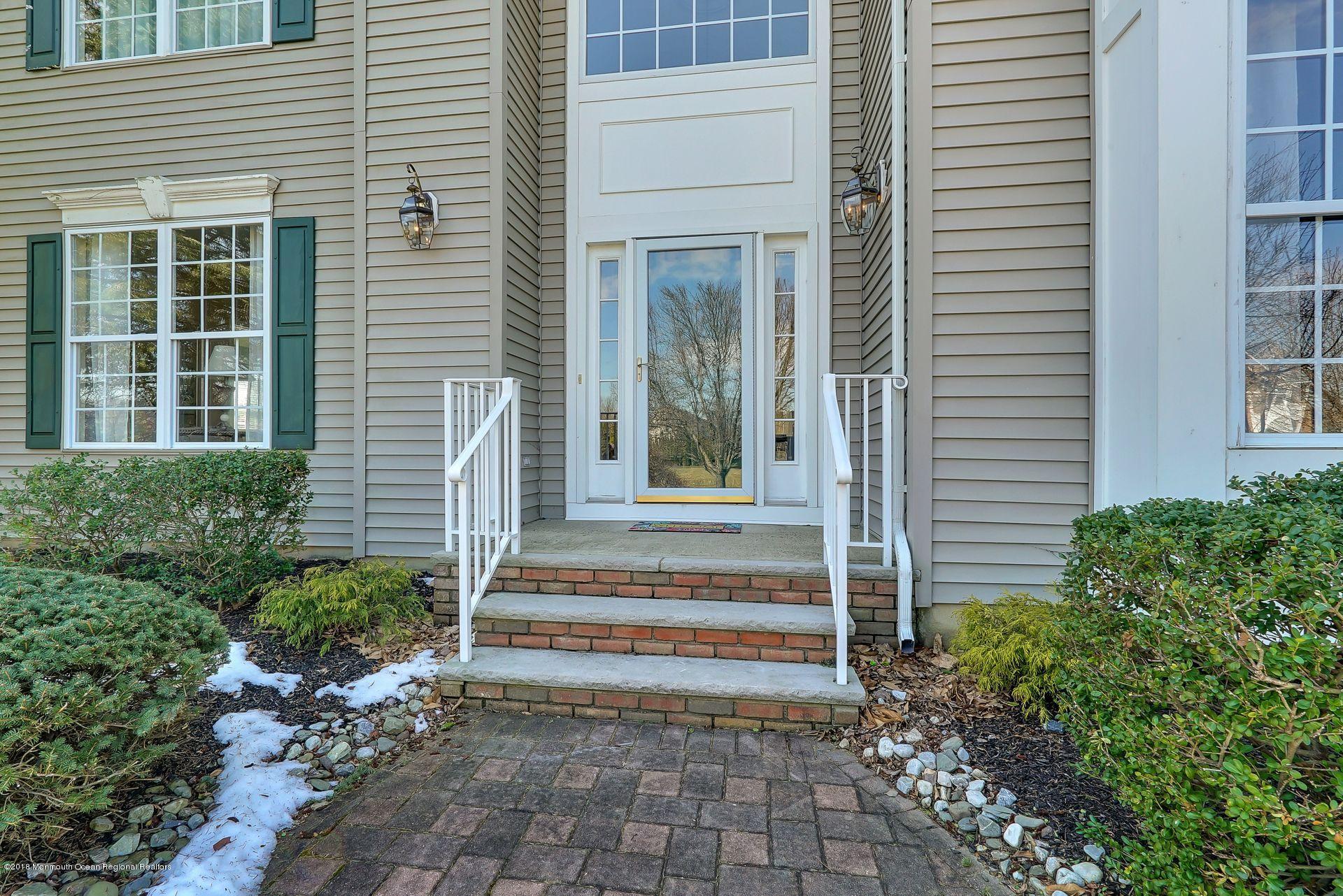 263 Pin Oak Road Freehold, NJ 07728 - Photo 8 of 60 a view of a house with potted plants and a bench