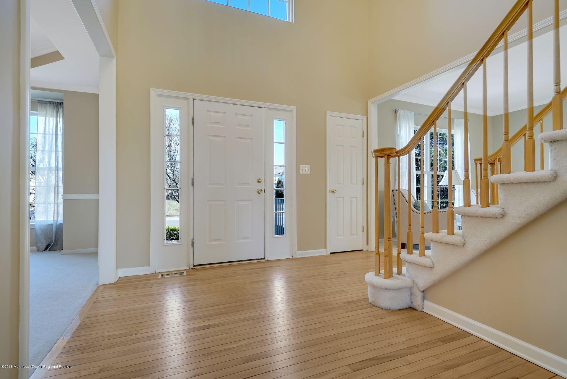 263 Pin Oak Road Freehold, NJ 07728 - Photo 9 of 60 a view of an entryway with wooden floor and staircase