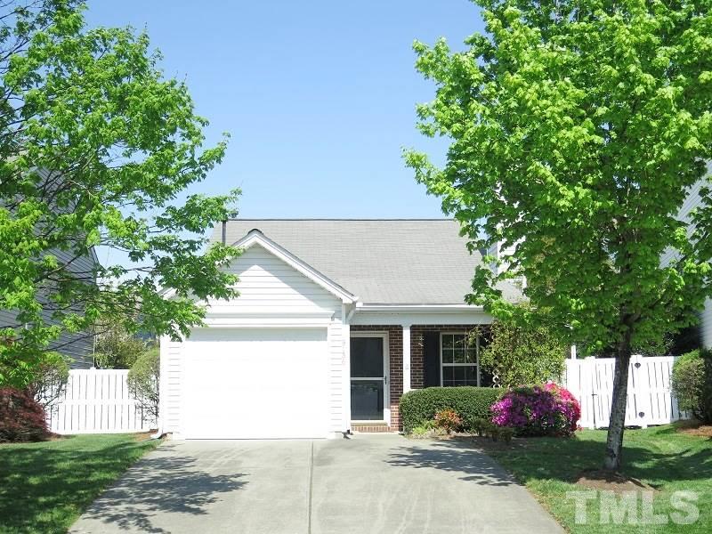 9136 Shallcross Way Raleigh, NC 27617 - Photo 1 of 13 a front view of a house with garden