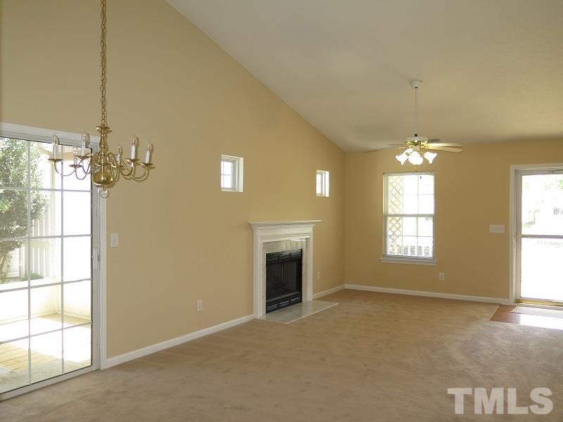 9136 Shallcross Way Raleigh, NC 27617 - Photo 3 of 13 a view of a livingroom with a chandelier fan and fire place