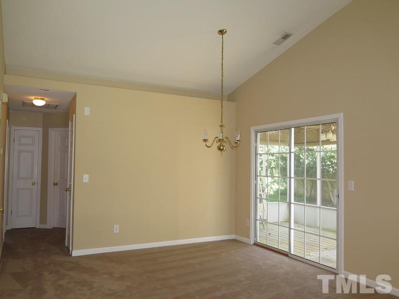9136 Shallcross Way Raleigh, NC 27617 - Photo 4 of 13 a view of empty room with windows