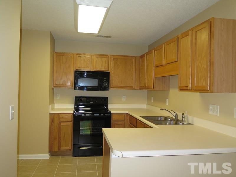 9136 Shallcross Way Raleigh, NC 27617 - Photo 6 of 13 a kitchen with a sink a stove and refrigerator